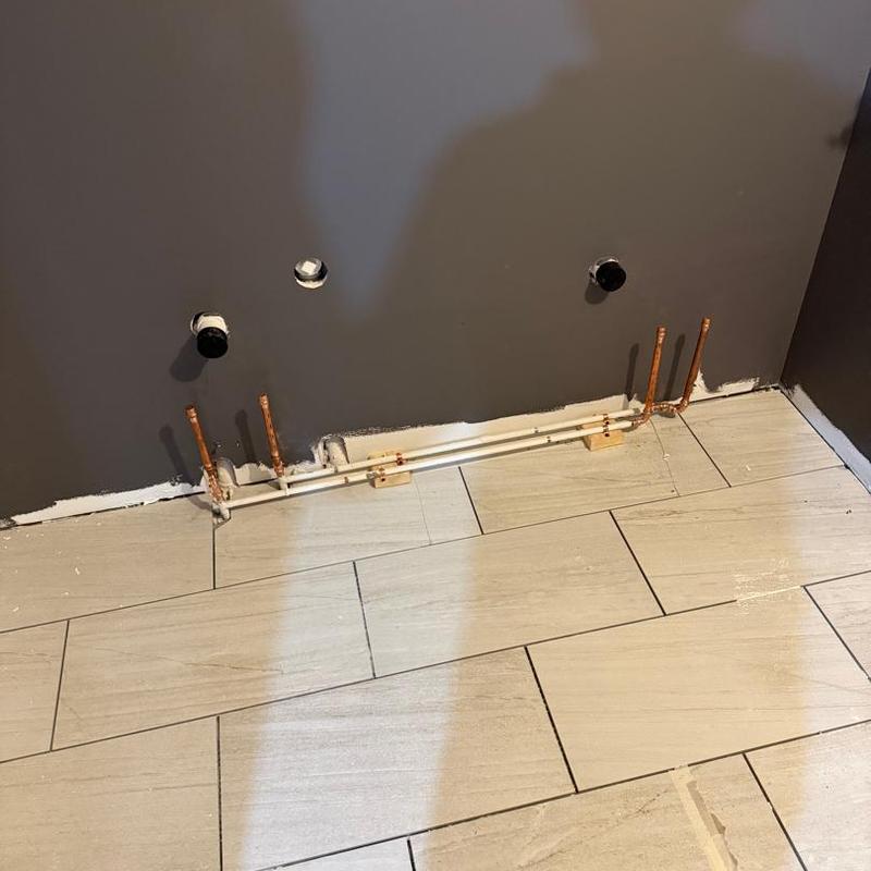 Copper water and gas lines installed in kitchen wall