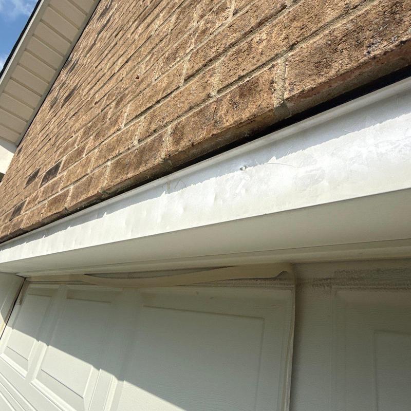 Garage door frame with paint damage and warping