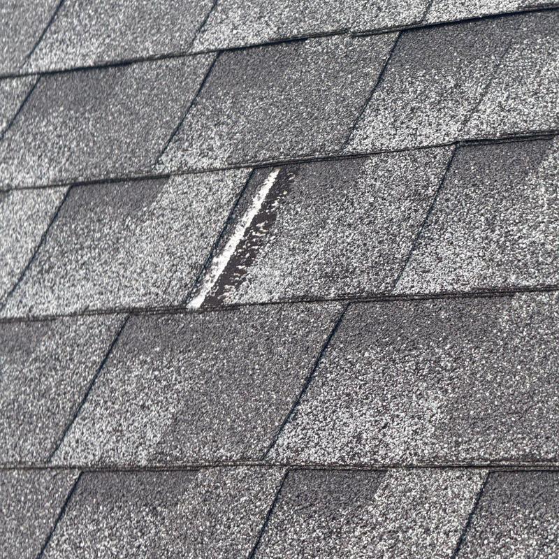 Roof shingles with hail damage and wear marks