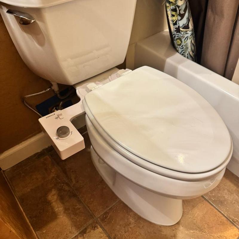 Toilet bidet seat installation in bathroom corner