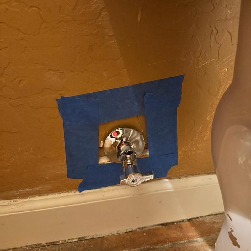 Angle stop valve on copper pipe with drywall cutout