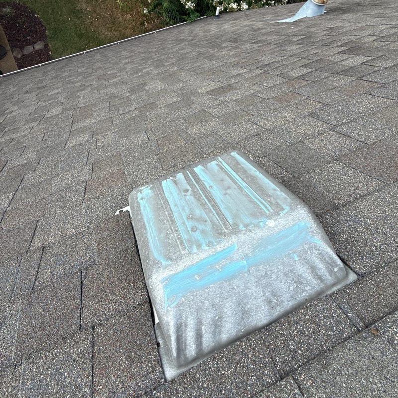 Roof vent with paint wear on asphalt shingles