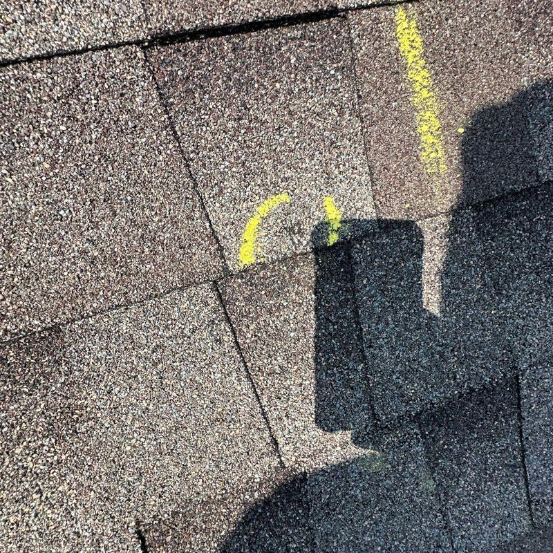 Asphalt shingles with marked hail damage and wear