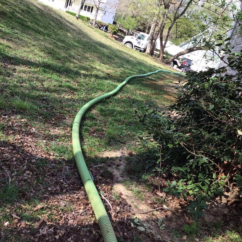 Septic tank suction hose laid in yard