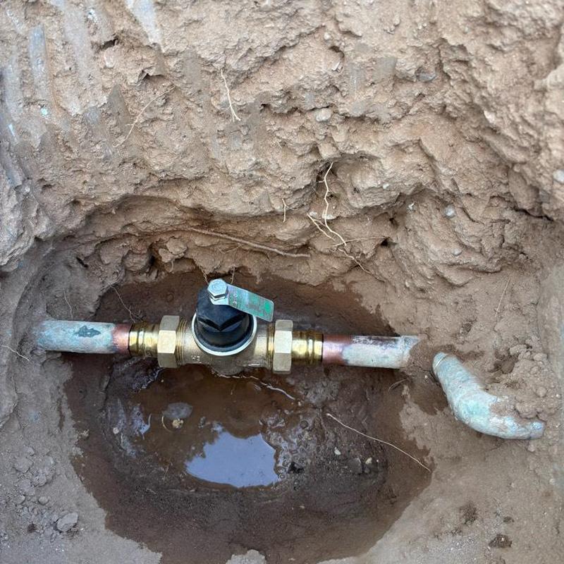 One-inch pressure relief valve with tan access box underground