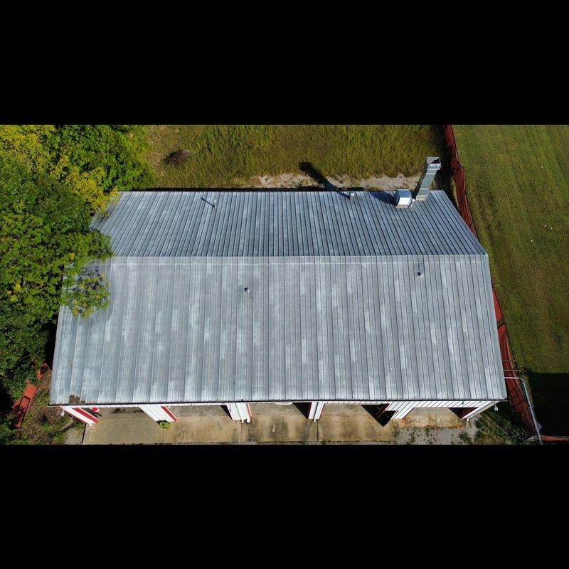 Metal commercial roof with hail damage inspection