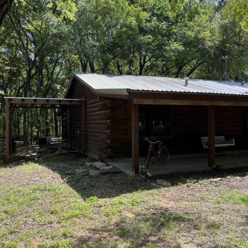 Metal panel roofing on wood cabin exterior