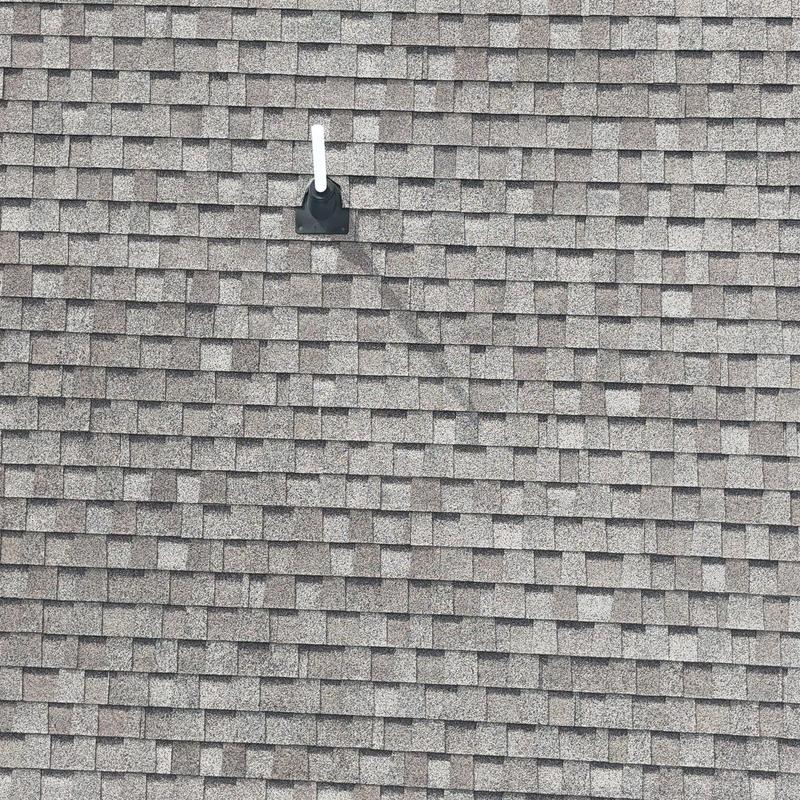 Asphalt shingle roof with visible hail damage and plumbing vent