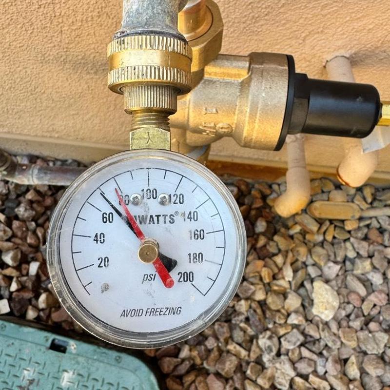 Pressure gauge on brass hose bib with valves and pipes