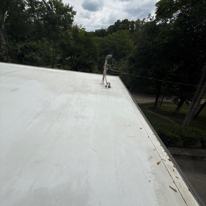 Flat roof with satellite dish and trees background