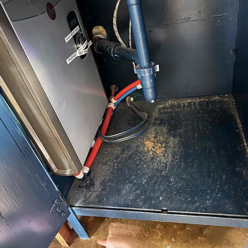 Tankless water heater with connected red and blue pipes