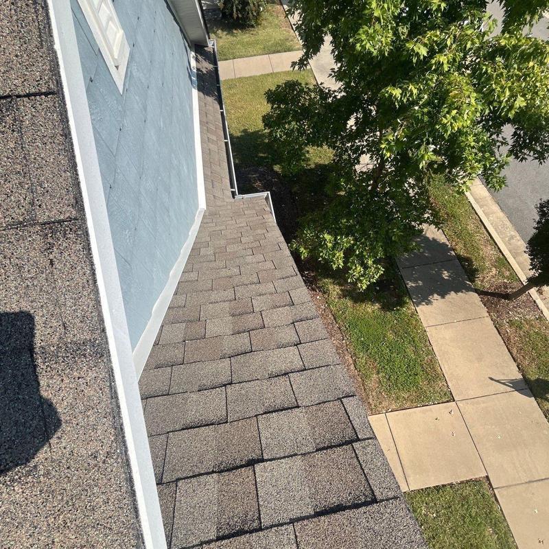 Asphalt shingle roof with visible wear and damage