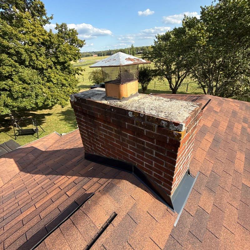 Chimney flashing on shingle roof with vent cap