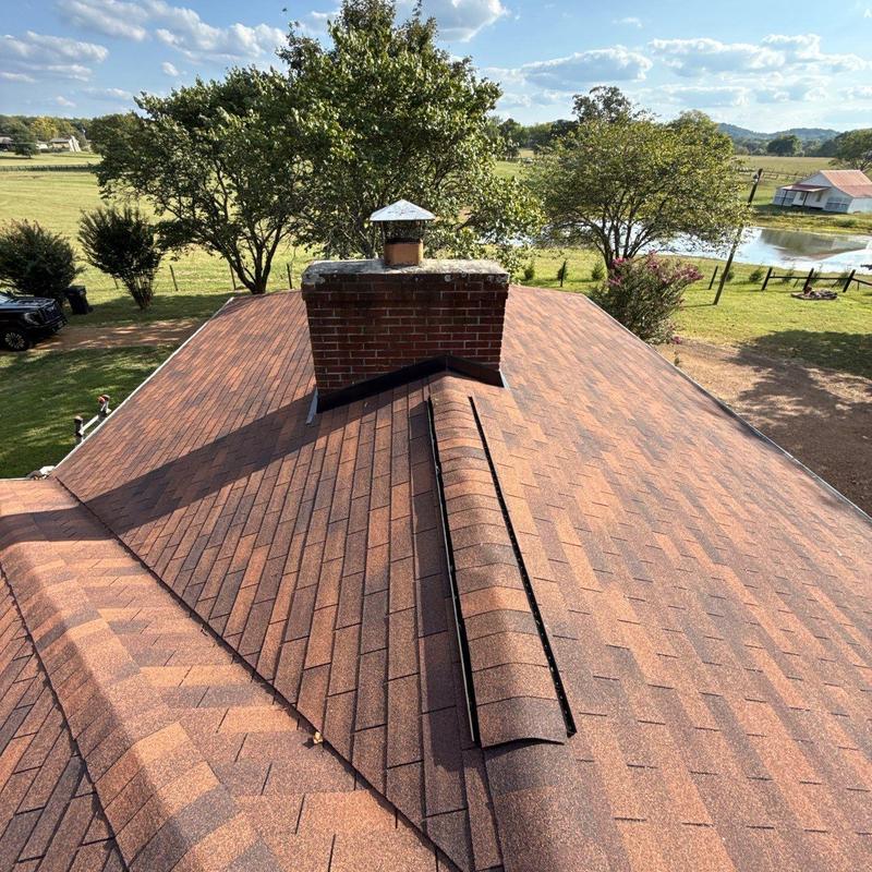 Asphalt roof shingles with chimney and ridge vent