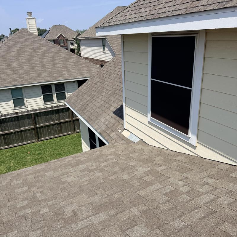 Asphalt shingle roof with window trim and flashing
