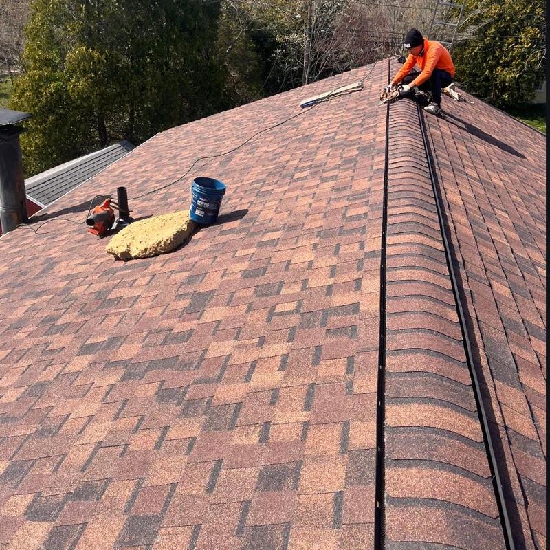 Asphalt shingle roof installation with ridge vent detail