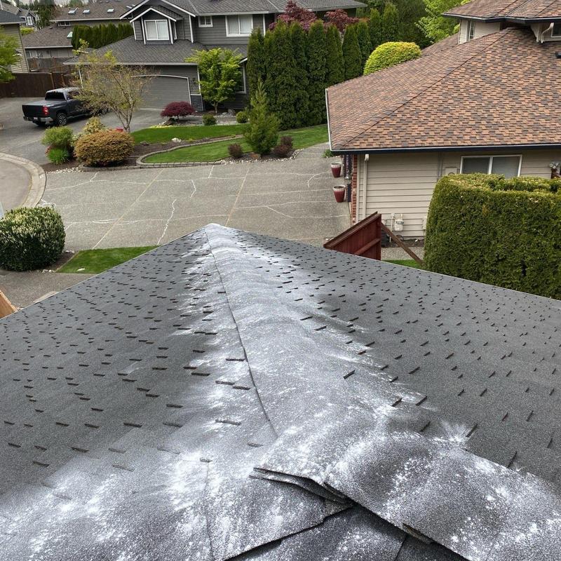Asphalt shingle roof with cleaning residue on surface