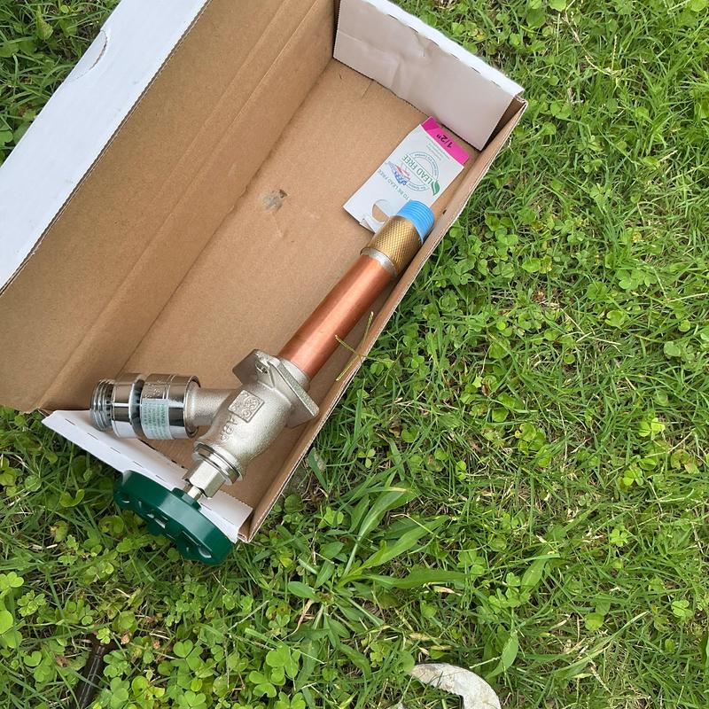 4-inch hose bibb assembly in cardboard box on grass