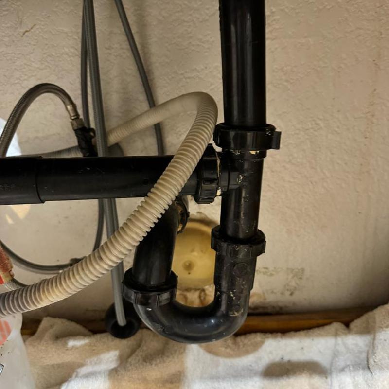 Garbage disposal with new drain flange installed under sink