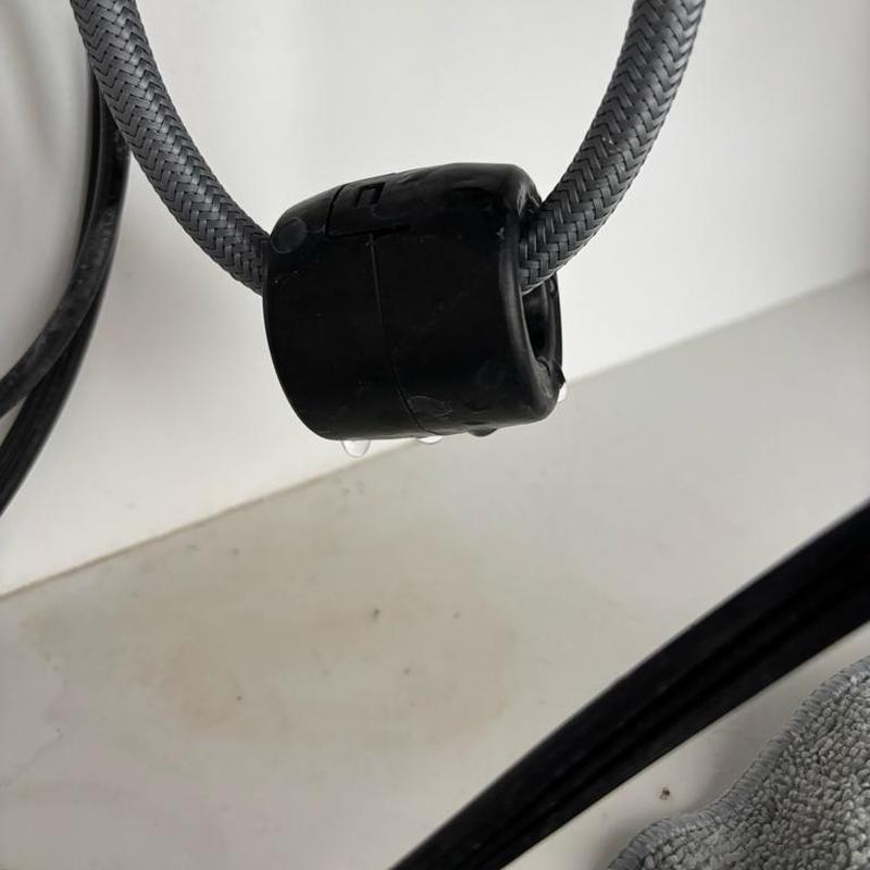 Kitchen faucet supply line with water leak droplets
