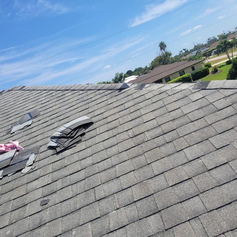 Shingle roof with removed failing shingles and vents