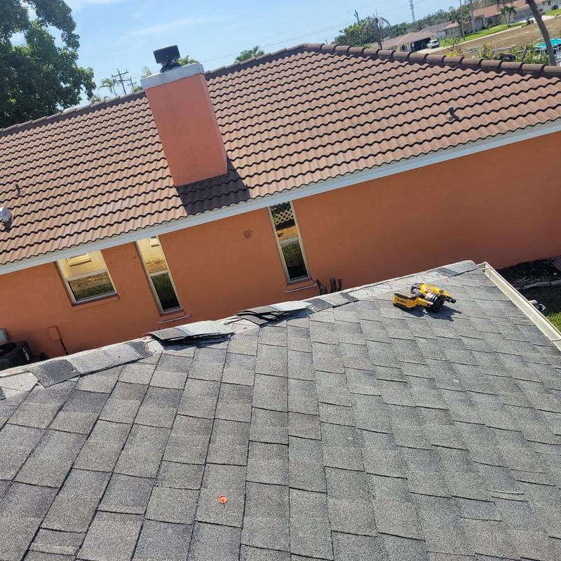 Asphalt shingle roof with tools during repair