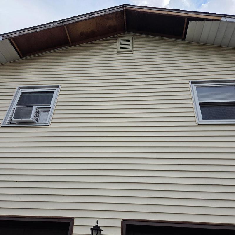 Soffit system with missing panels on house exterior