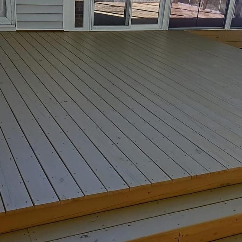 Wooden deck flooring with steps near sliding glass door Wooden deck flooring with steps near sliding glass door