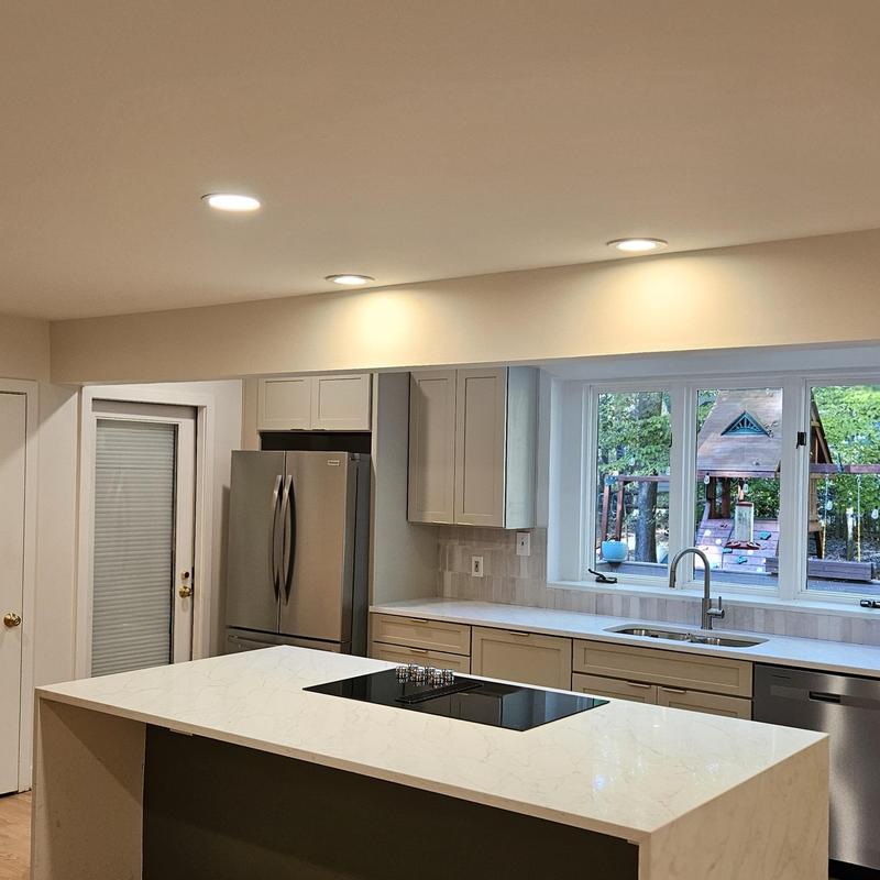 Kitchen island with cooktop and marble countertop