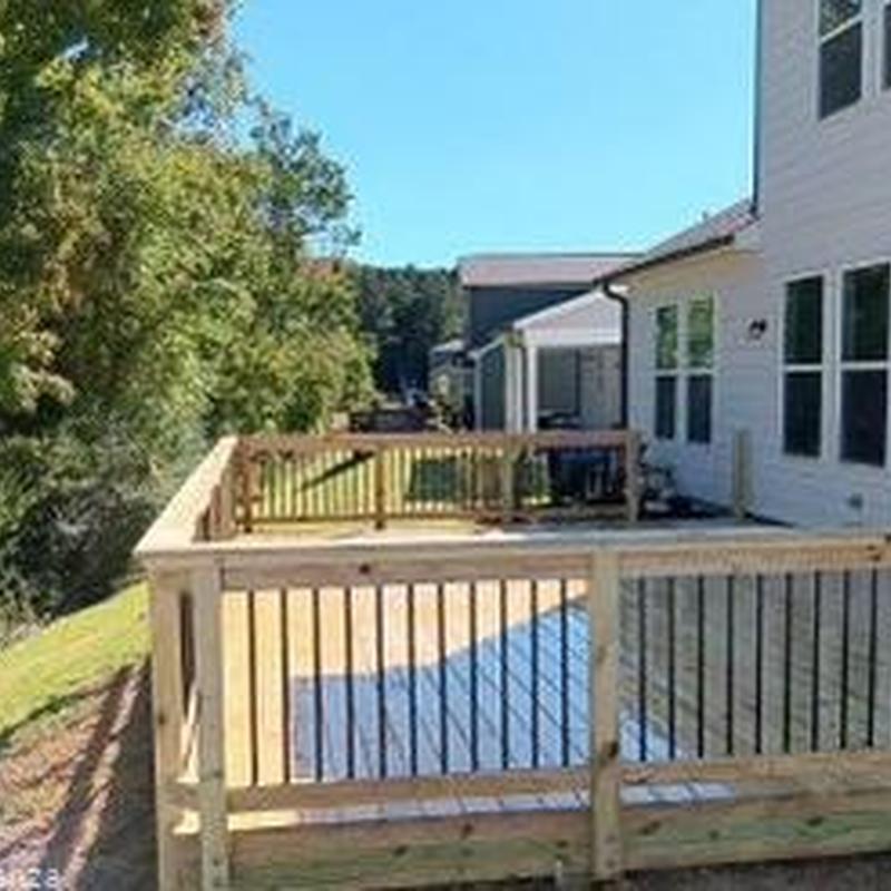 Wooden deck with railing installation in backyard Wooden deck with railing installation in backyard