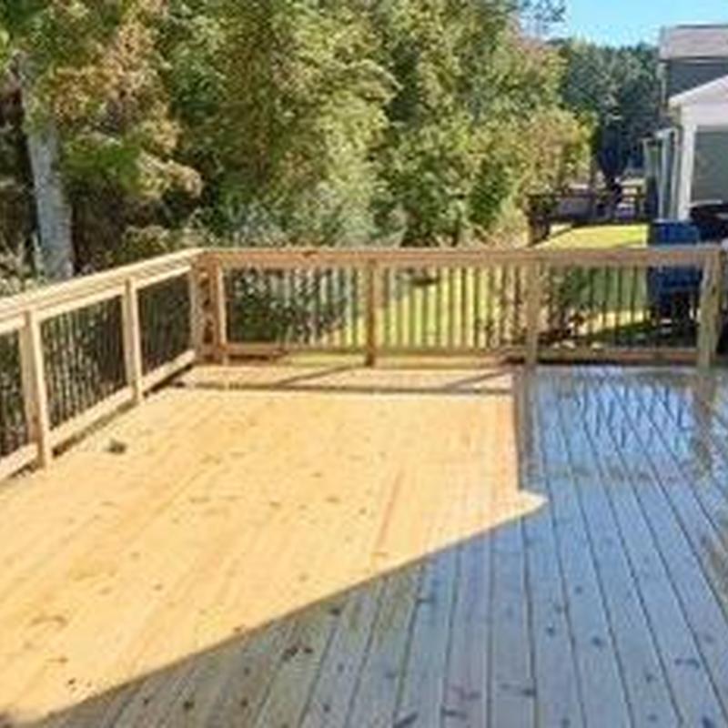 Wooden deck with railing in backyard Wooden deck with railing in backyard