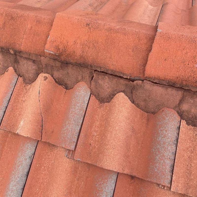 Tile roof cracked and damaged areas close-up view