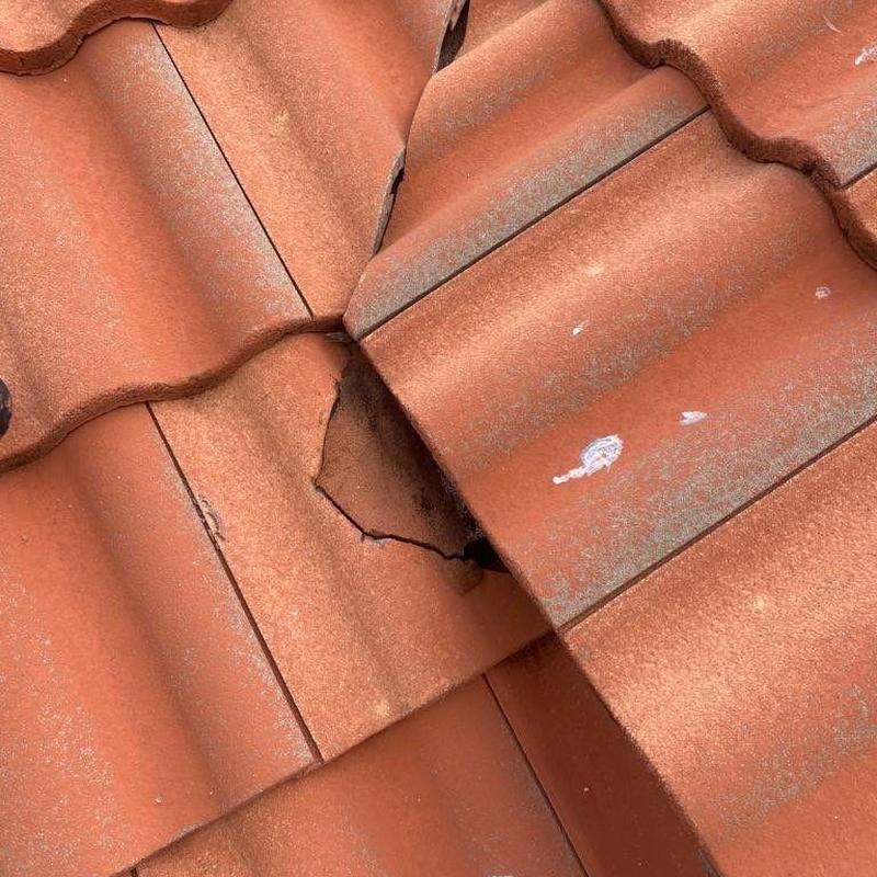 Cracked tile on red Spanish tile roof system