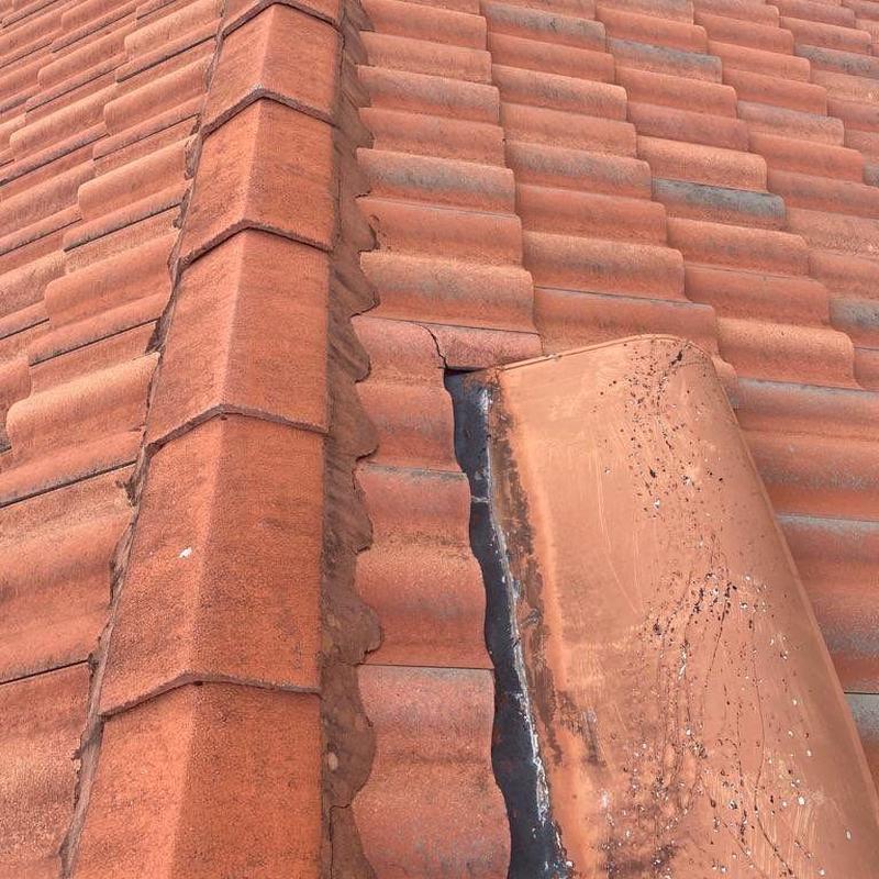 Tile roof cracked and damaged ridge tiles close-up view