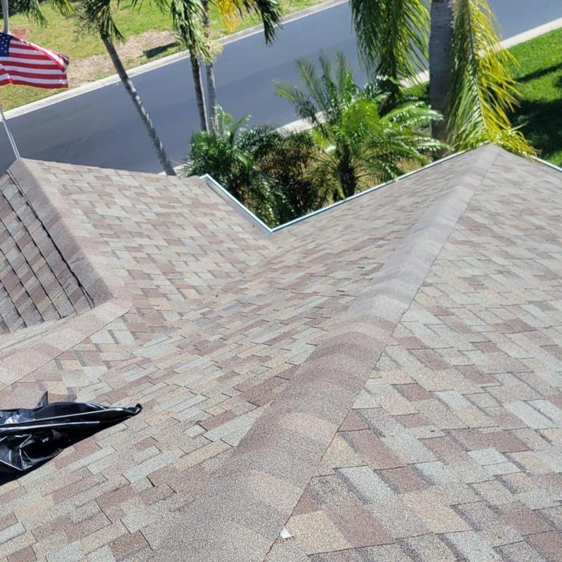 Shingle roof with repaired ridge and vents