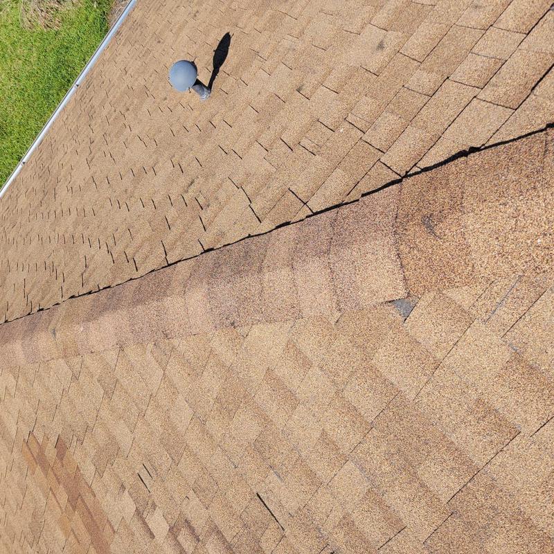 Asphalt shingle roof with visible nail pops and damage