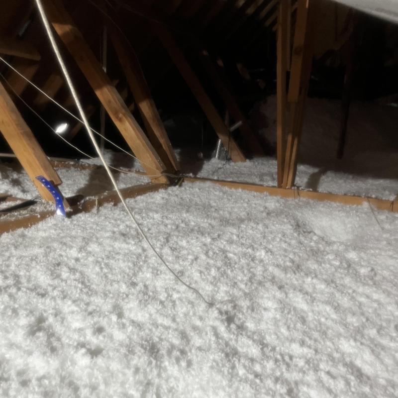 Attic insulation with blown-in fiberglass in Fort Worth attic