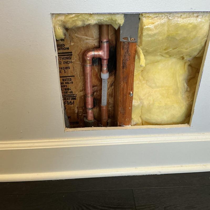 PEX pipe installation through copper plumbing behind wall panel