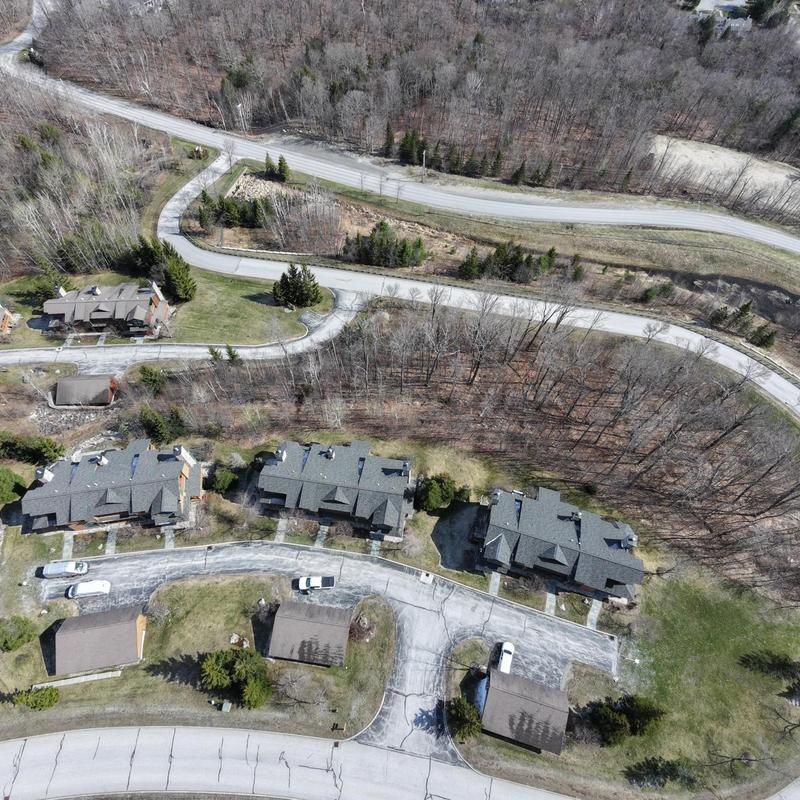 Asphalt shingle roofs on condo buildings aerial view