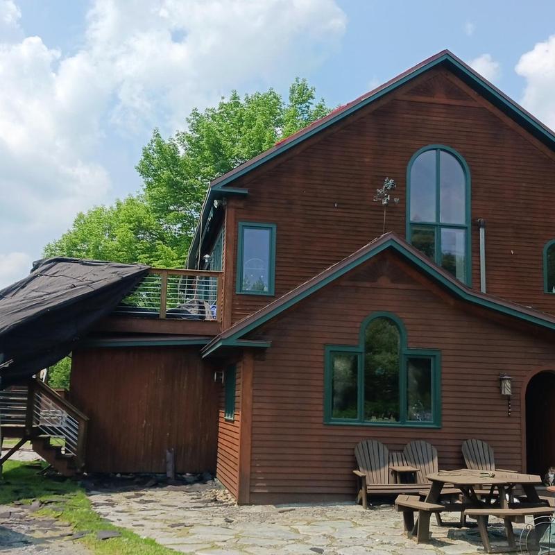 Asphalt shingle roof on wooden home with deck