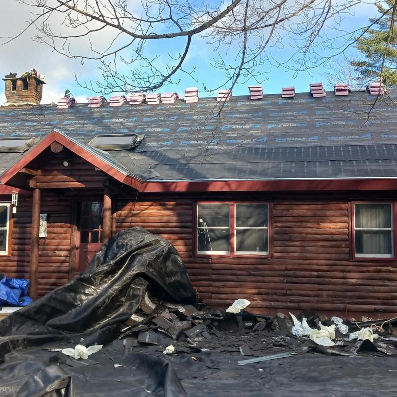 Architectural shingle roof installation on log cabin