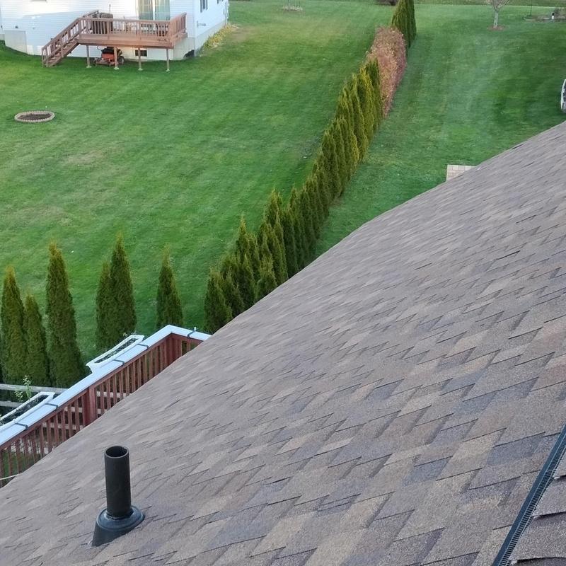 Architectural shingle roof with vent pipe and gutter guard