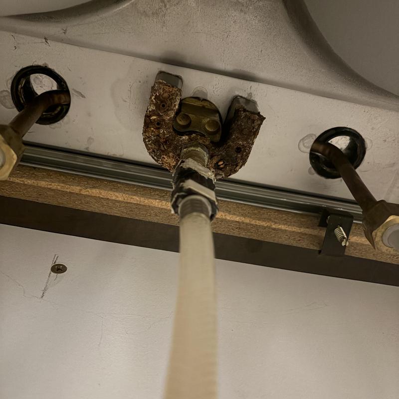 Corroded kitchen faucet supply line connection under sink