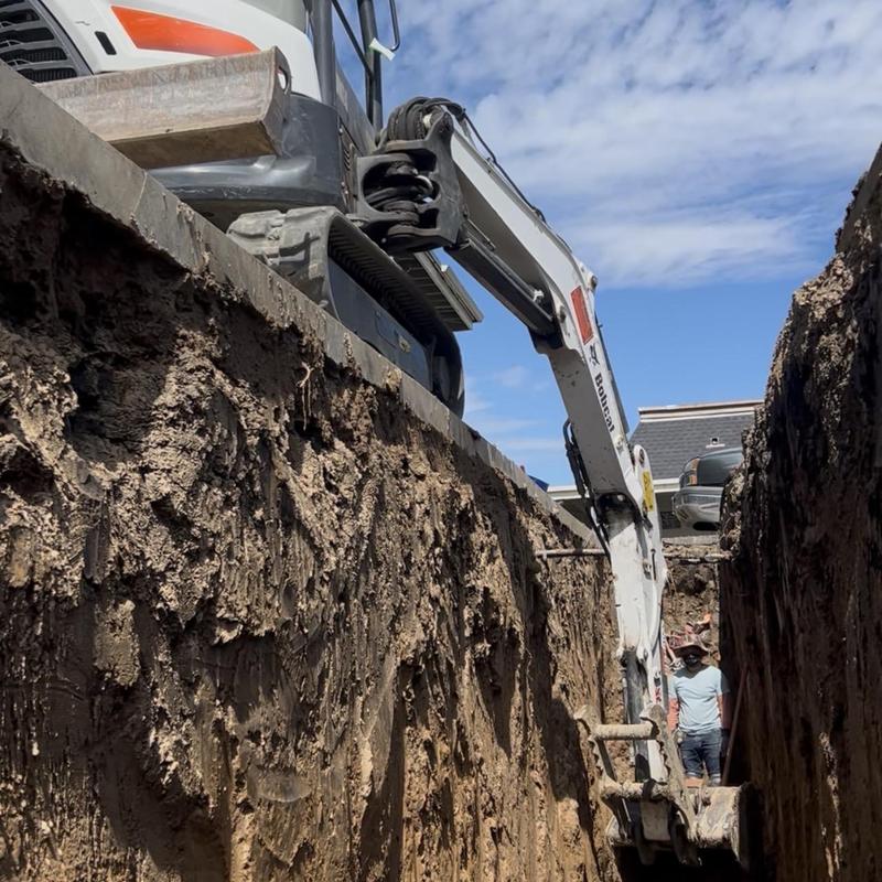 8-inch sewer pipe installation trench with Bobcat excavator