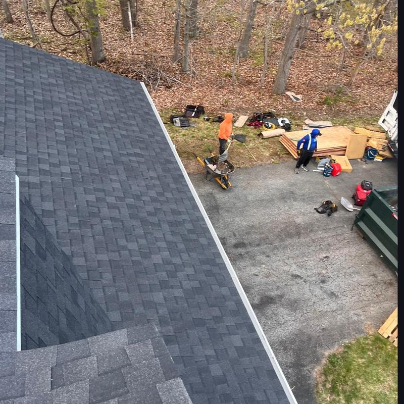 Asphalt shingle roof with installed gutter toppers
