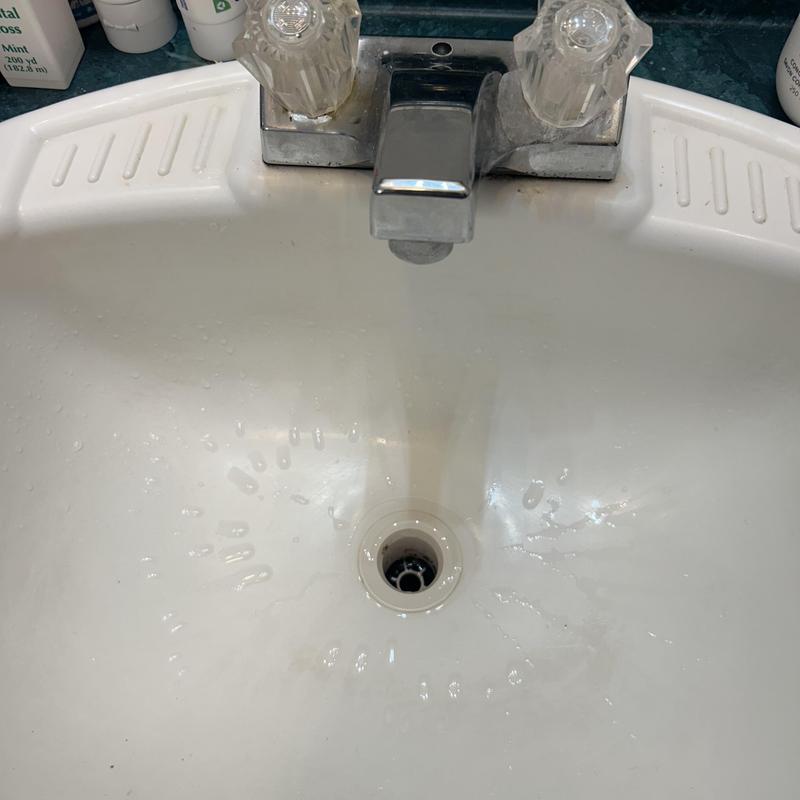 Laboratory faucet with flowing water in sink Laboratory faucet with flowing water in sink