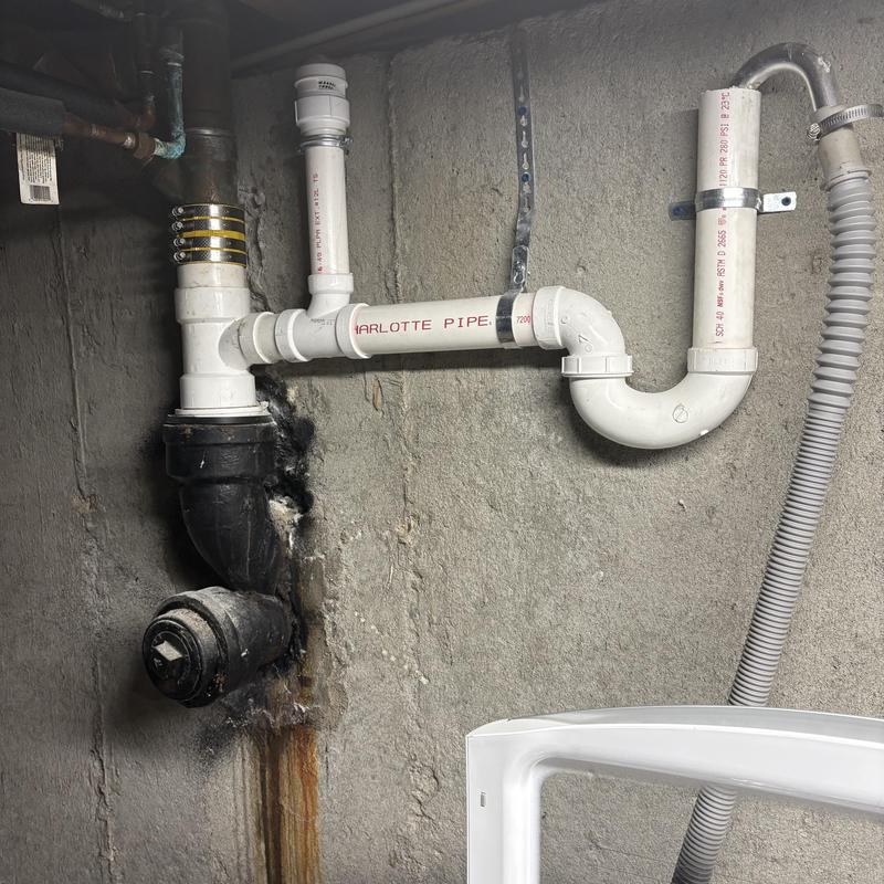 PVC laundry drain pipe connected to cast-iron Y stack