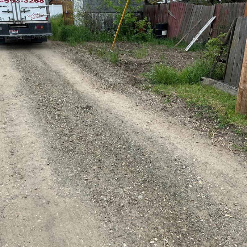 Excavation site with sunken dirt needing fill and compaction