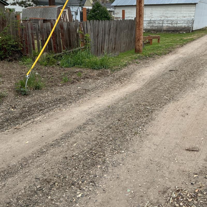 Excavation site soil filling and compaction near fence