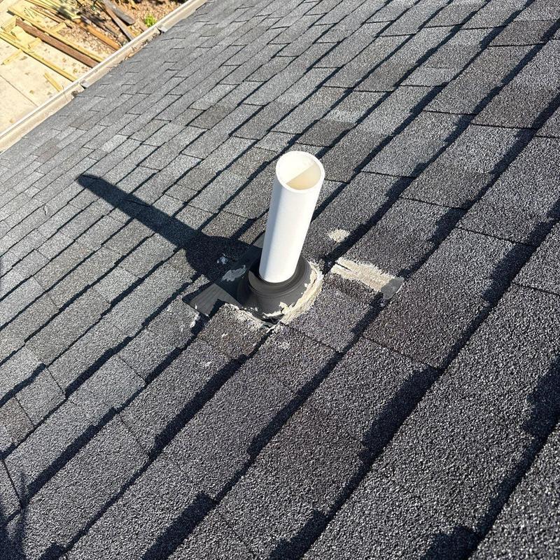 Roof vent flashing with worn sealant on shingles